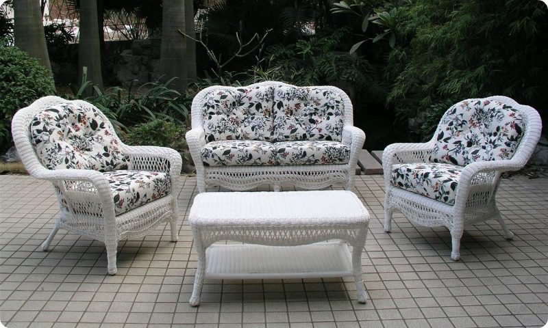 white outdoor furniture with beautifully patterned floral cushions